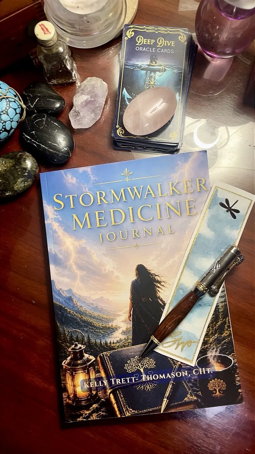 Stormwalker Medicine Journal resting among oracle cards, crystals, and a handwritten bookmark